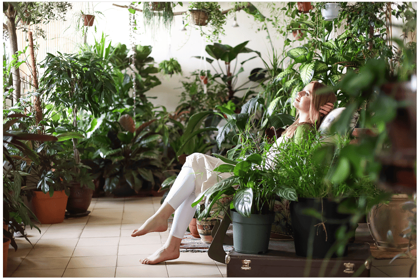 woman relaxing in room with plants